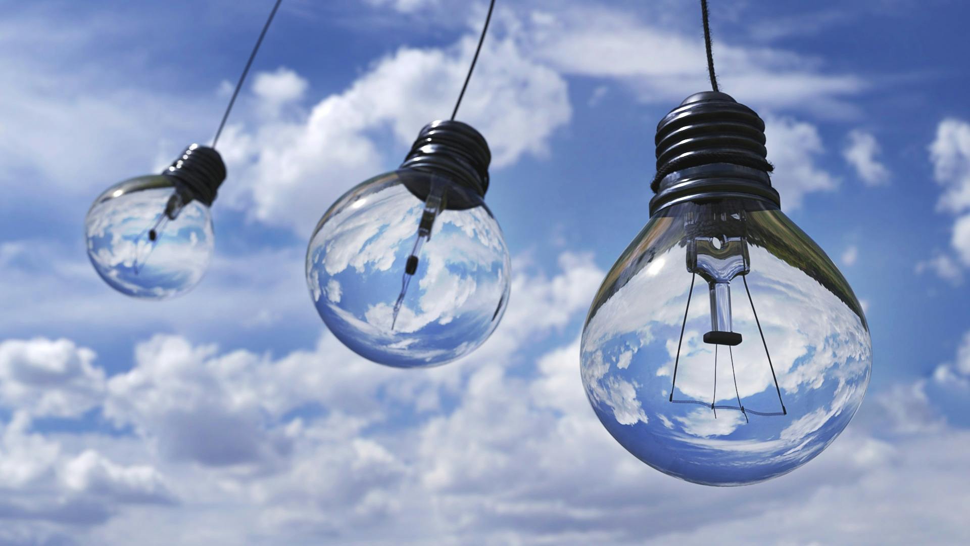 pexels-photo-207489-207489 Surreal image of light bulbs reflecting blue sky and clouds, symbolizing creativity and energy.